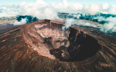 Clouds rolling over the opening of a volcano.